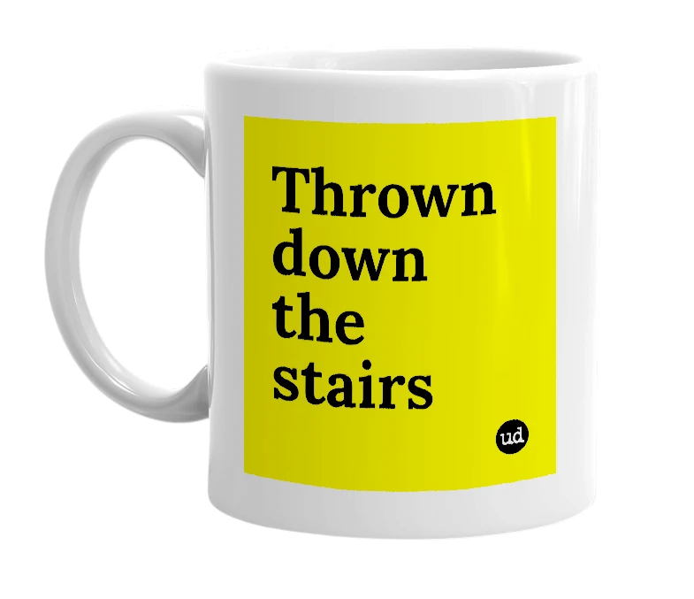 White mug with 'Thrown down the stairs' in bold black letters