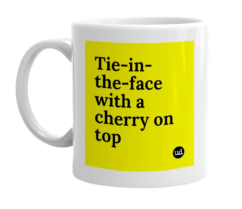 White mug with 'Tie-in-the-face with a cherry on top' in bold black letters