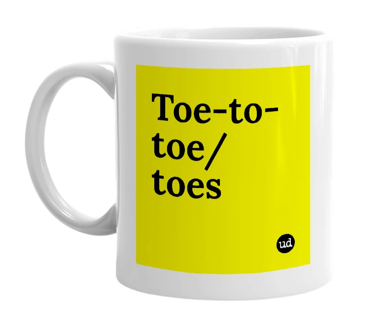 White mug with 'Toe-to-toe/toes' in bold black letters