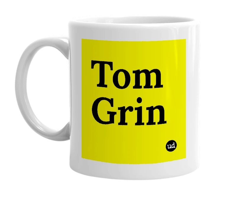 White mug with 'Tom Grin' in bold black letters