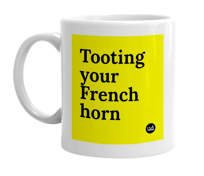 White mug with 'Tooting your French horn' in bold black letters