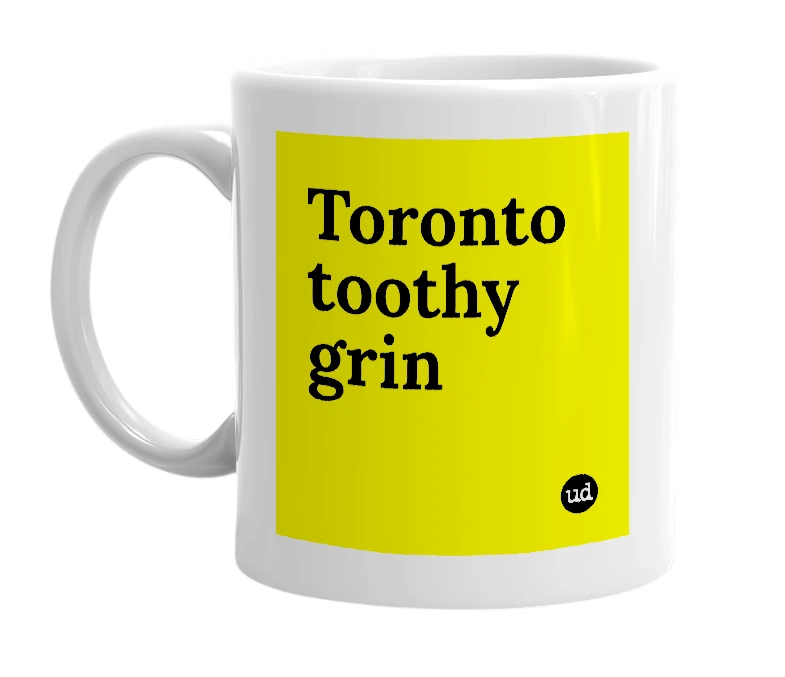 White mug with 'Toronto toothy grin' in bold black letters