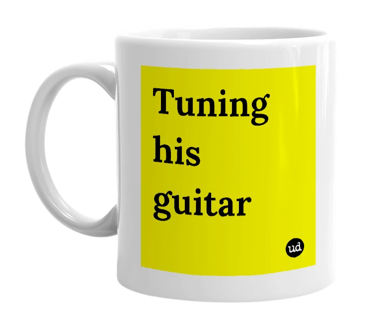 White mug with 'Tuning his guitar' in bold black letters