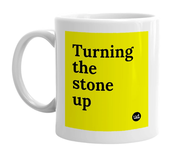 White mug with 'Turning the stone up' in bold black letters
