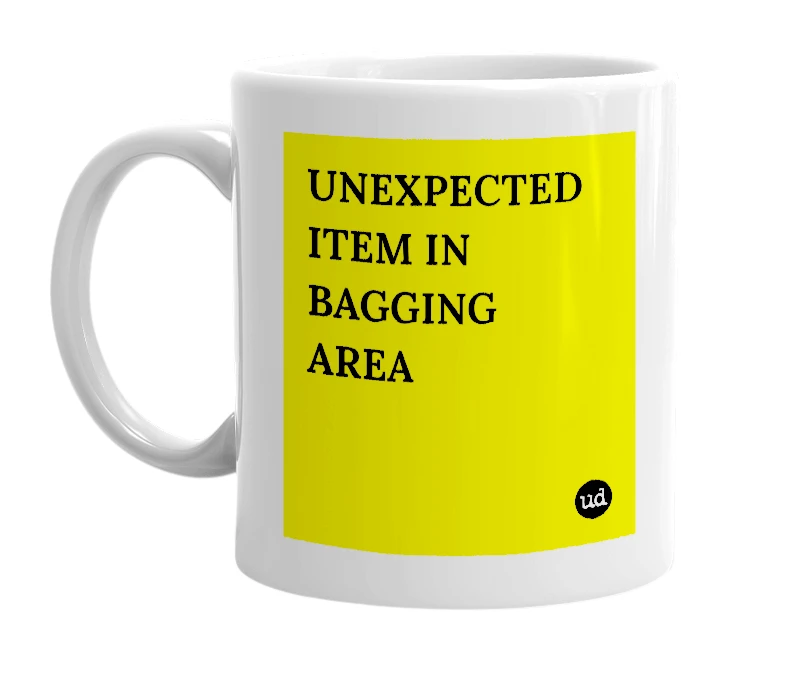 White mug with 'UNEXPECTED ITEM IN BAGGING AREA' in bold black letters
