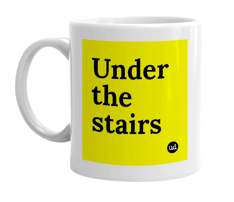 White mug with 'Under the stairs' in bold black letters