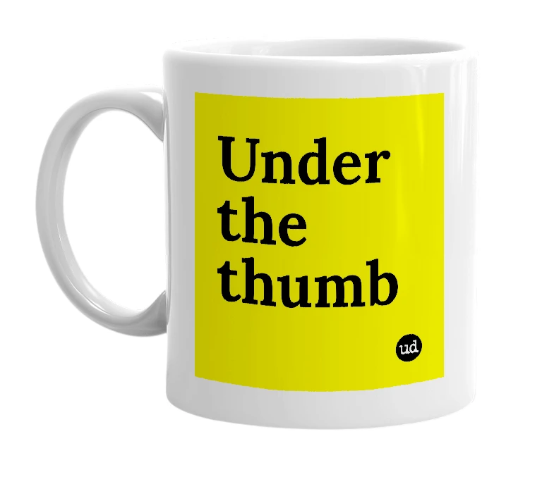 White mug with 'Under the thumb' in bold black letters