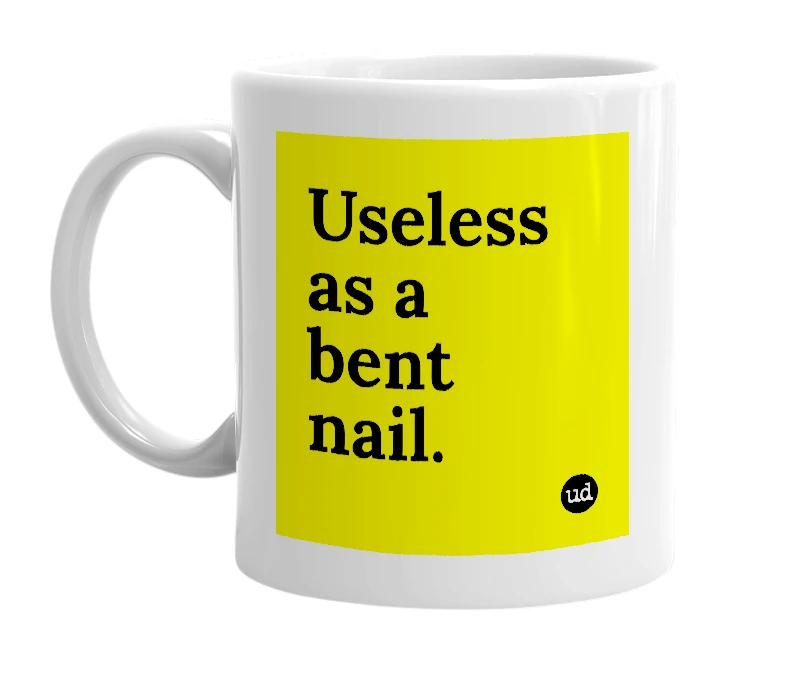 White mug with 'Useless as a bent nail.' in bold black letters