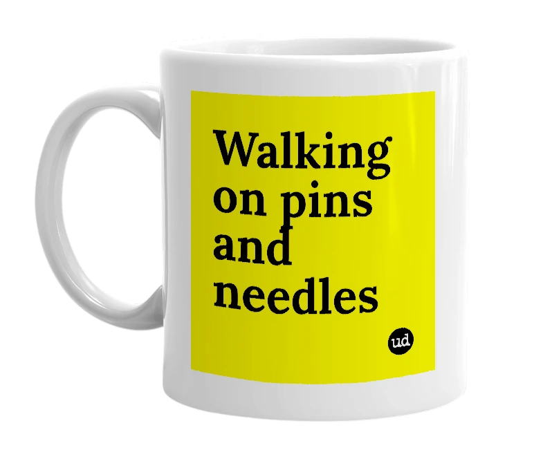 White mug with 'Walking on pins and needles' in bold black letters