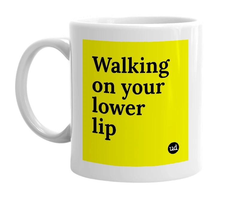 White mug with 'Walking on your lower lip' in bold black letters