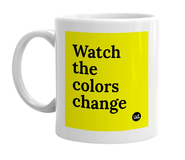 White mug with 'Watch the colors change' in bold black letters