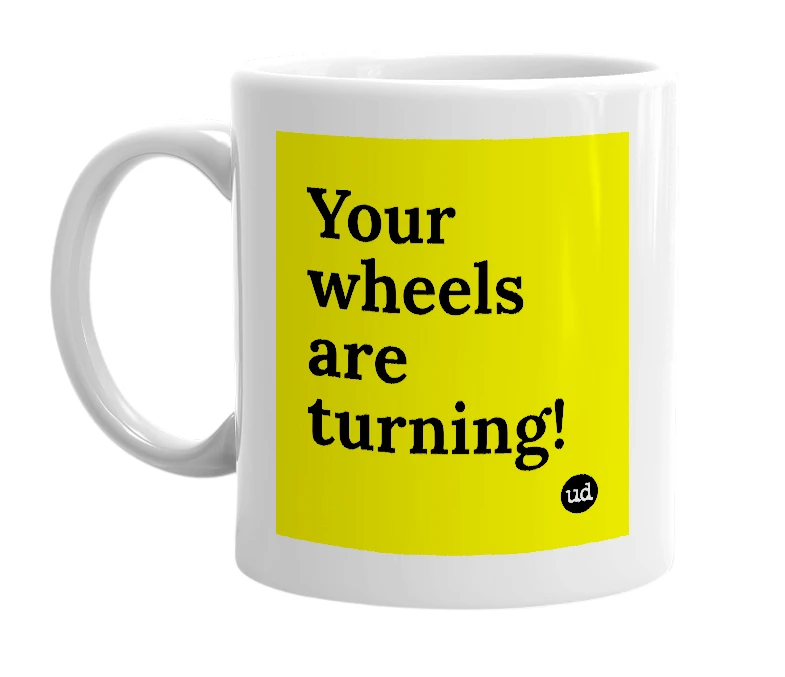 White mug with 'Your wheels are turning!' in bold black letters