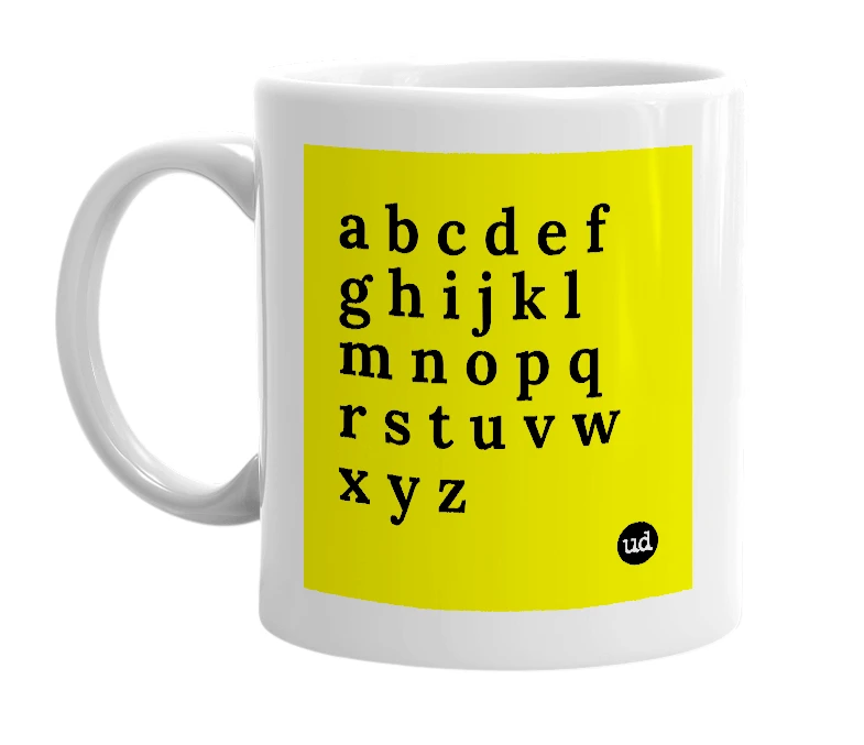 White mug with 'a b c d e f g h i j k l m n o p q r s t u v w x y z' in bold black letters