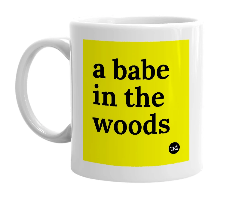 White mug with 'a babe in the woods' in bold black letters