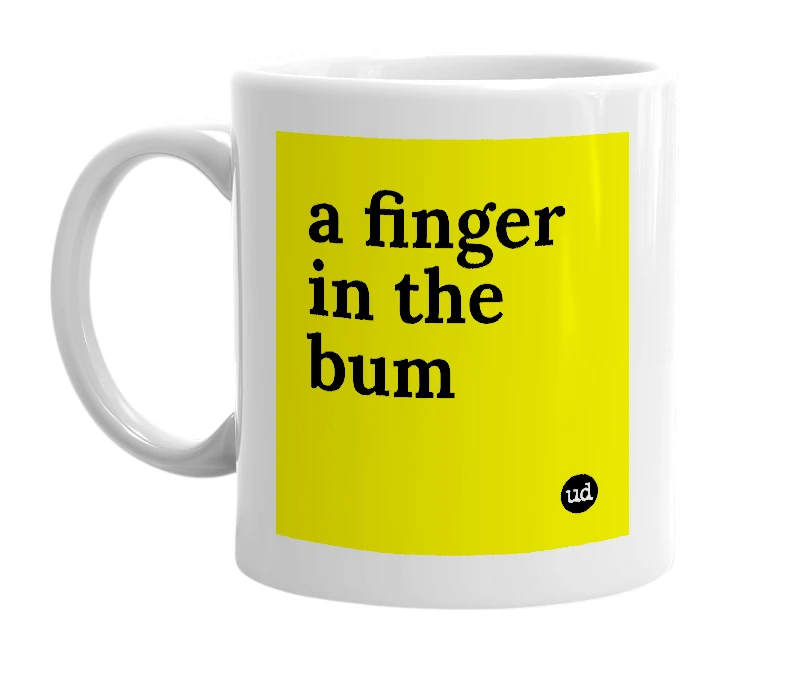 White mug with 'a finger in the bum' in bold black letters