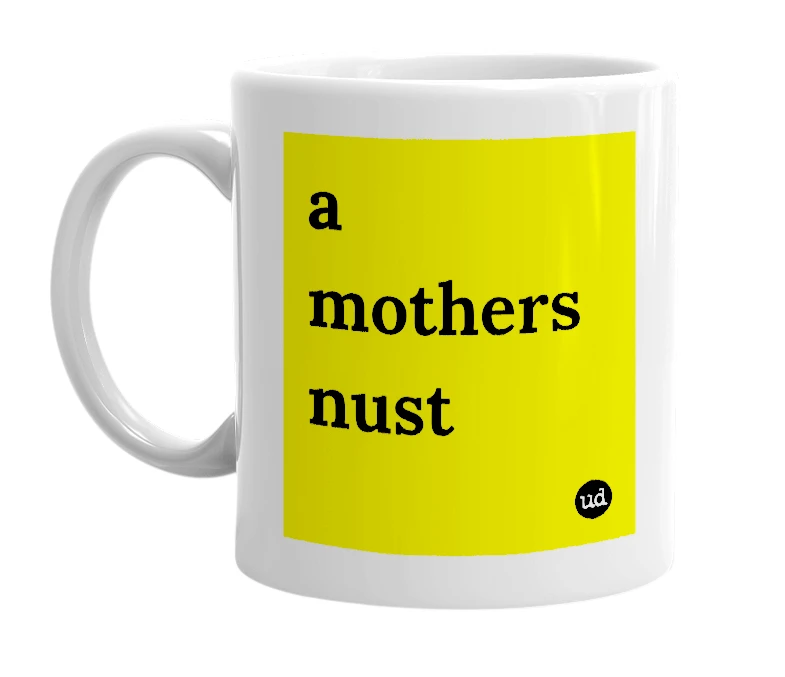 White mug with 'a mothers nust' in bold black letters