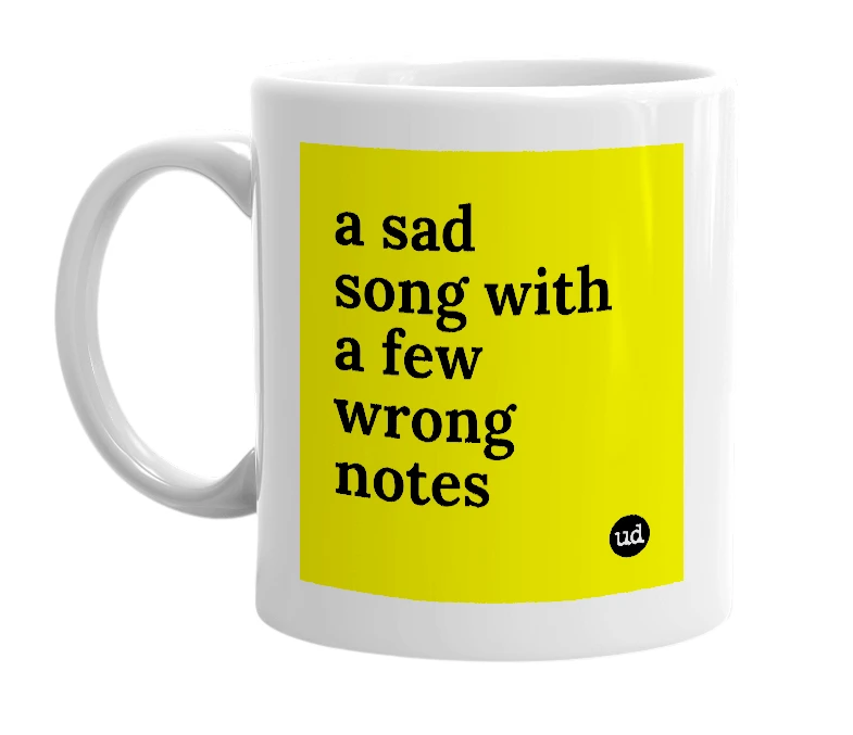 White mug with 'a sad song with a few wrong notes' in bold black letters