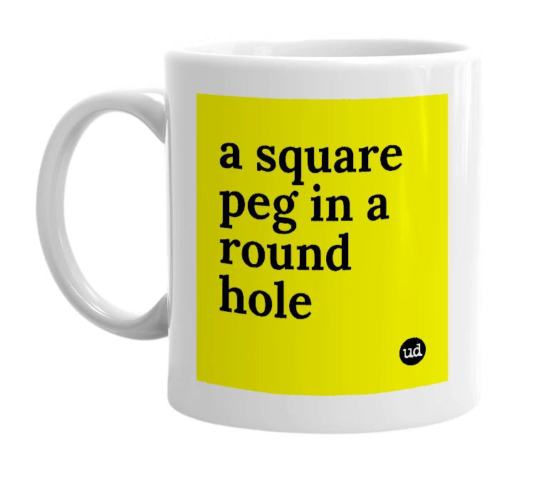 White mug with 'a square peg in a round hole' in bold black letters