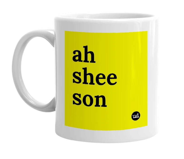 White mug with 'ah shee son' in bold black letters