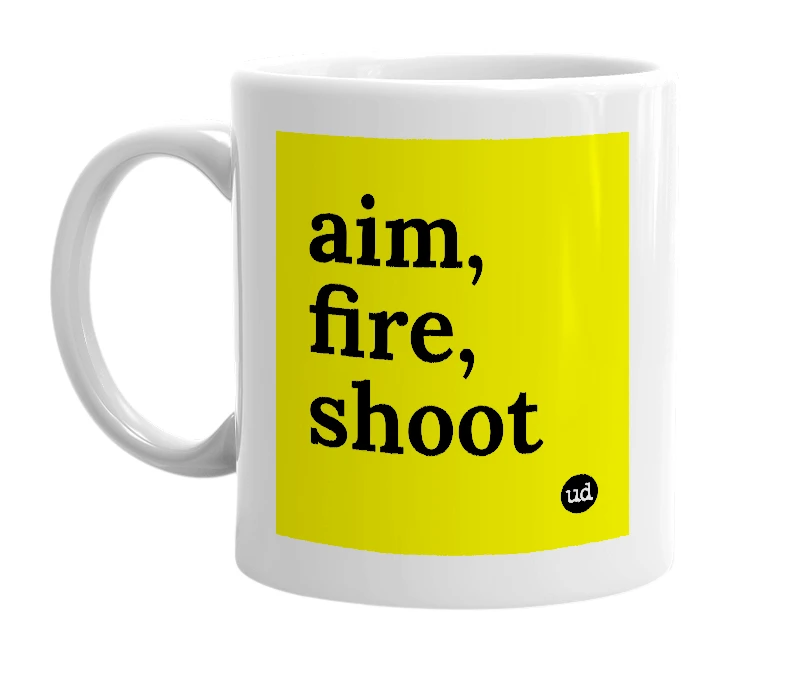 White mug with 'aim, fire, shoot' in bold black letters