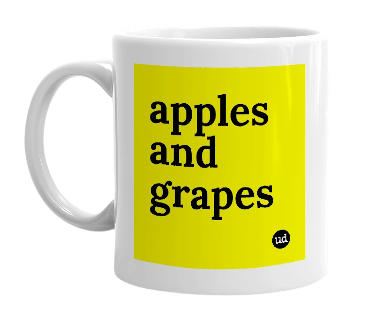White mug with 'apples and grapes' in bold black letters
