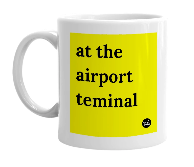White mug with 'at the airport teminal' in bold black letters