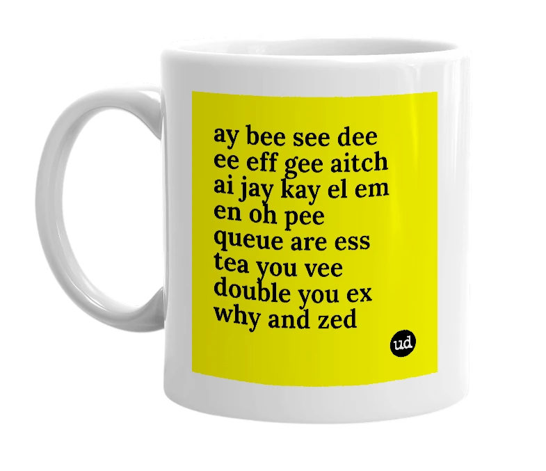 White mug with 'ay bee see dee ee eff gee aitch ai jay kay el em en oh pee queue are ess tea you vee double you ex why and zed' in bold black letters