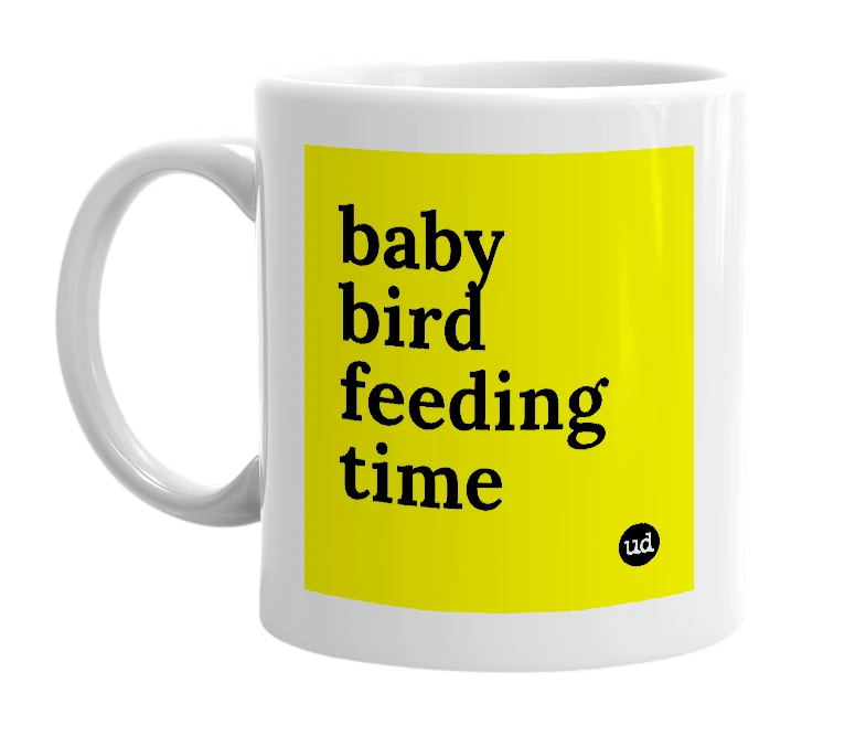 White mug with 'baby bird feeding time' in bold black letters