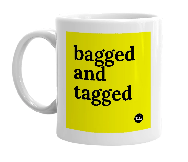 White mug with 'bagged and tagged' in bold black letters