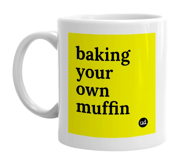 White mug with 'baking your own muffin' in bold black letters