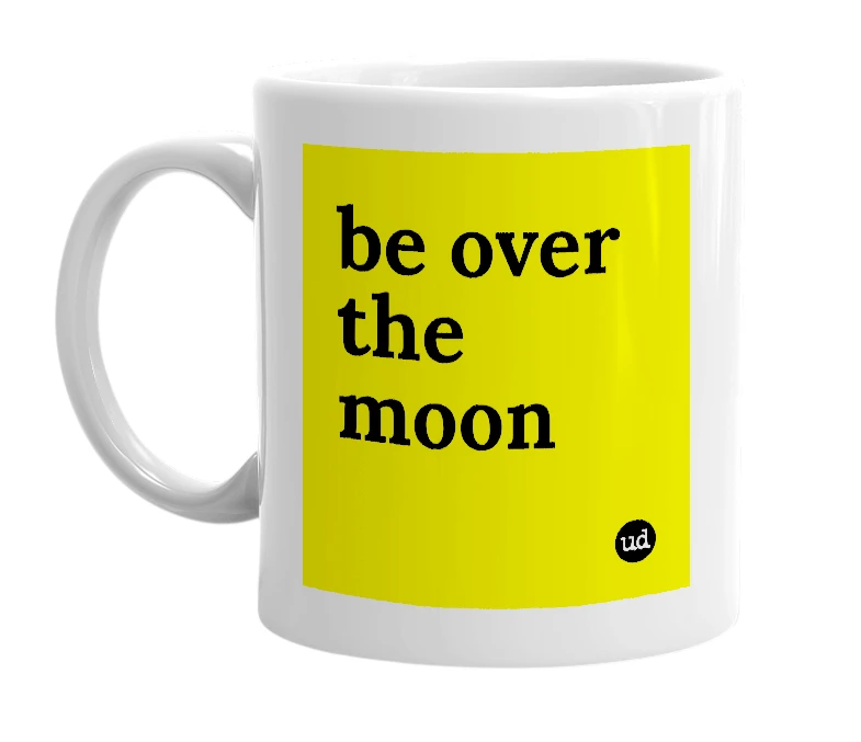 White mug with 'be over the moon' in bold black letters