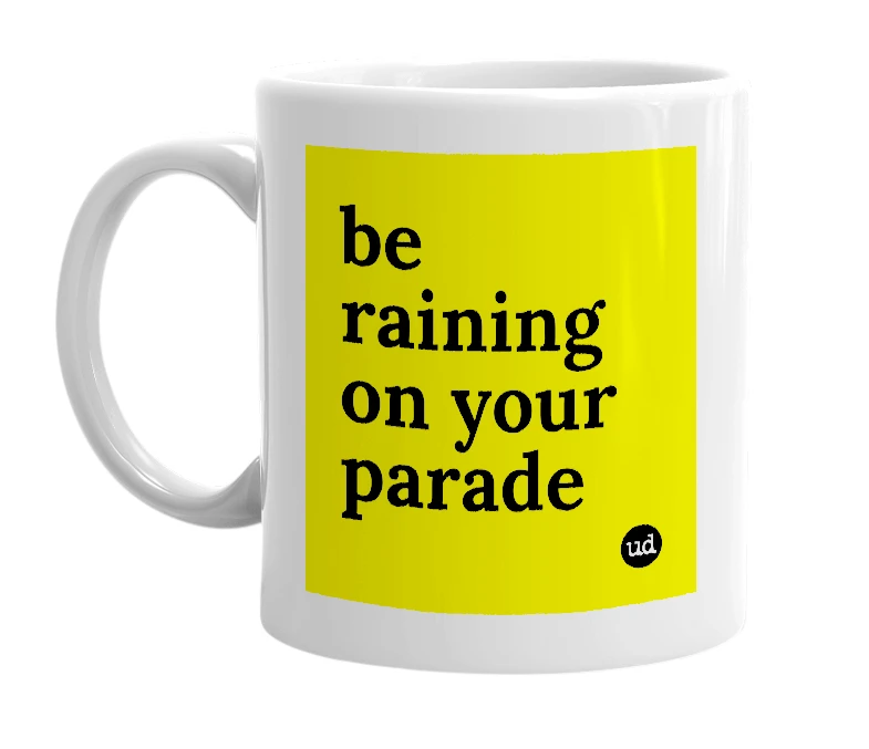 White mug with 'be raining on your parade' in bold black letters