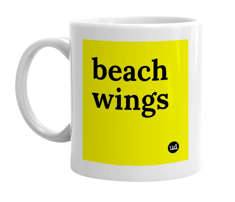 White mug with 'beach wings' in bold black letters