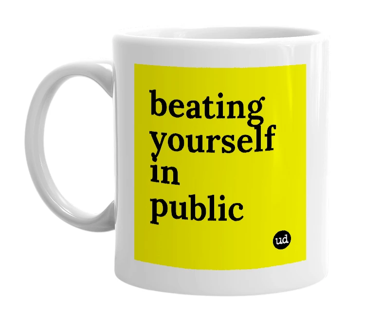 White mug with 'beating yourself in public' in bold black letters