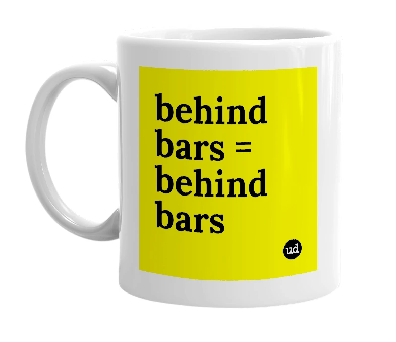 White mug with 'behind bars = behind bars' in bold black letters