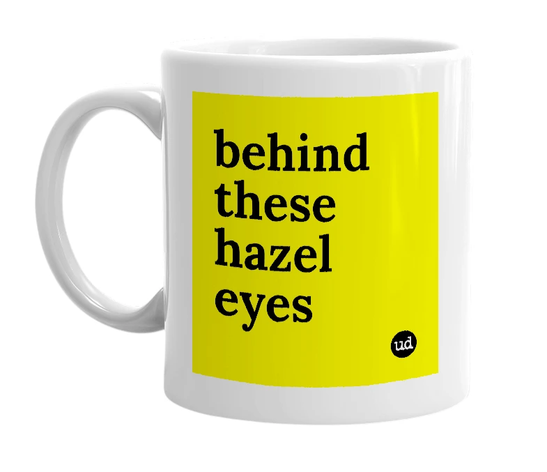 White mug with 'behind these hazel eyes' in bold black letters
