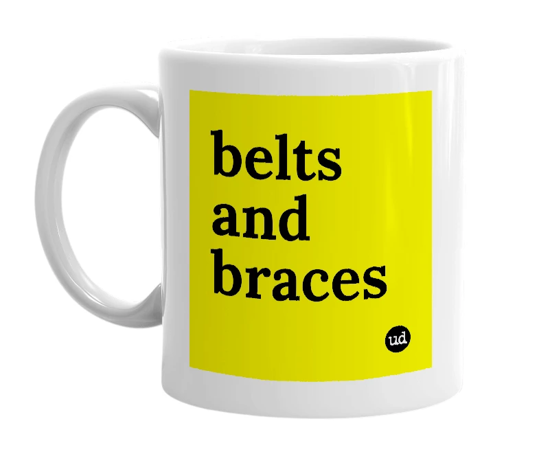 White mug with 'belts and braces' in bold black letters