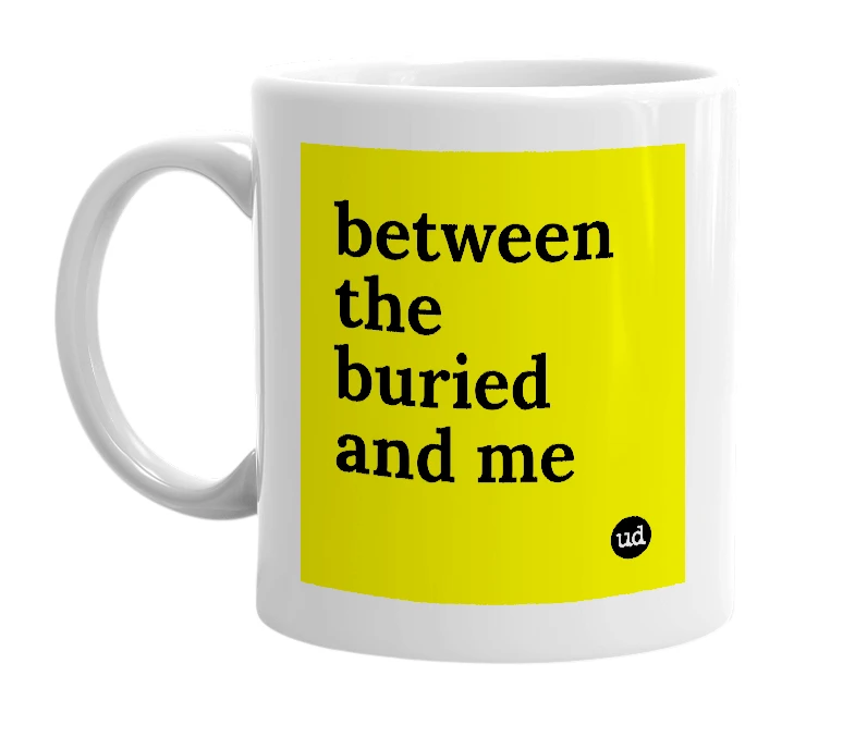 White mug with 'between the buried and me' in bold black letters