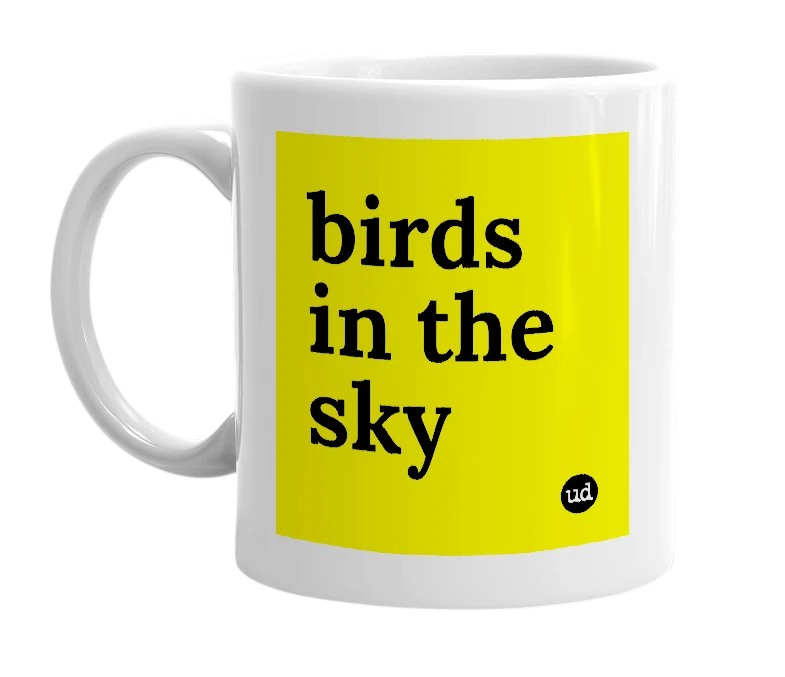 White mug with 'birds in the sky' in bold black letters