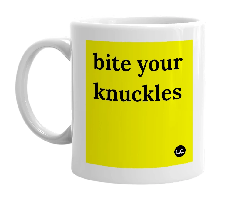 White mug with 'bite your knuckles' in bold black letters