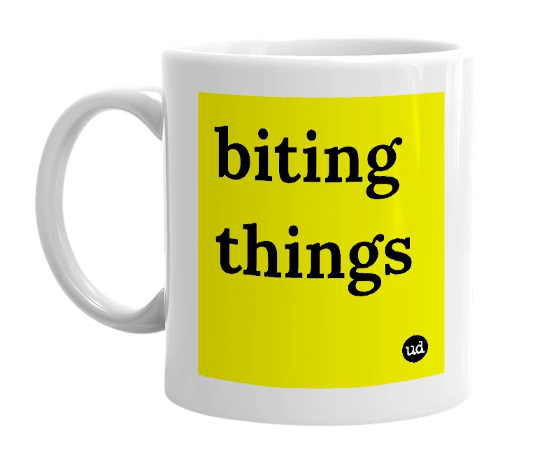 White mug with 'biting things' in bold black letters