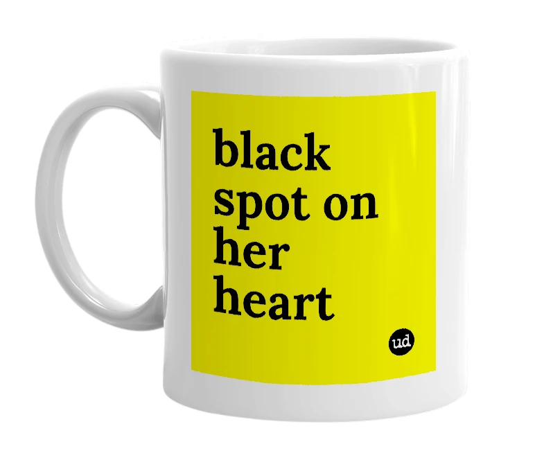 White mug with 'black spot on her heart' in bold black letters