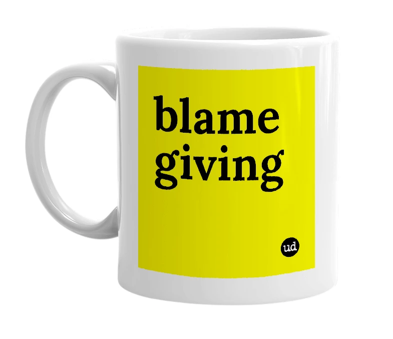 White mug with 'blame giving' in bold black letters