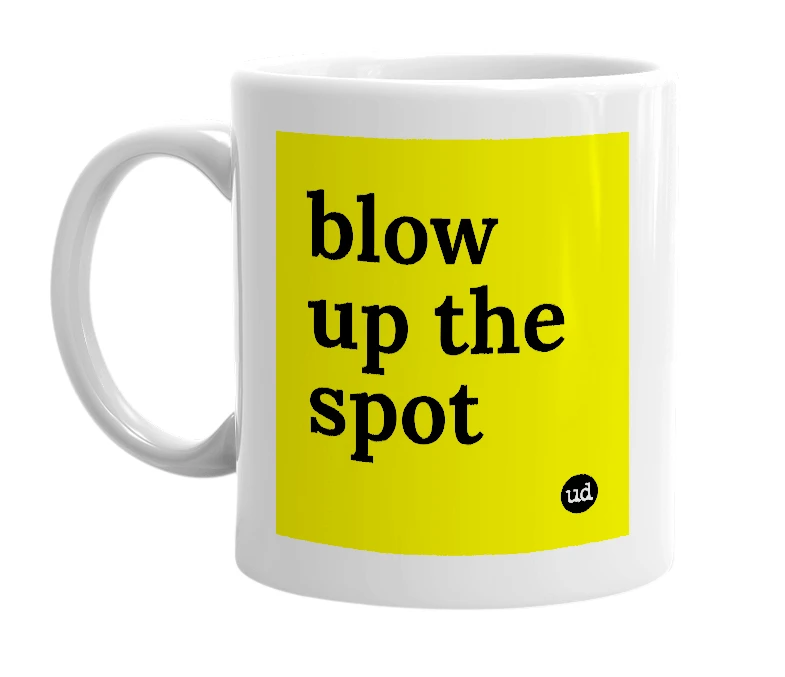 White mug with 'blow up the spot' in bold black letters