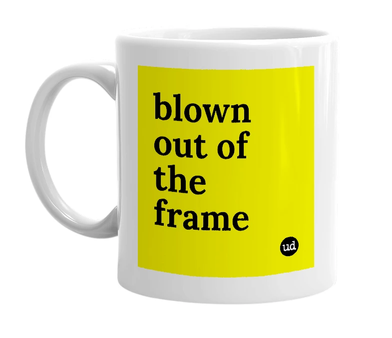 White mug with 'blown out of the frame' in bold black letters