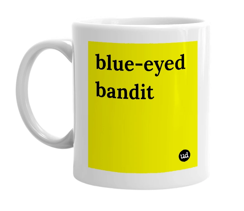 White mug with 'blue-eyed bandit' in bold black letters