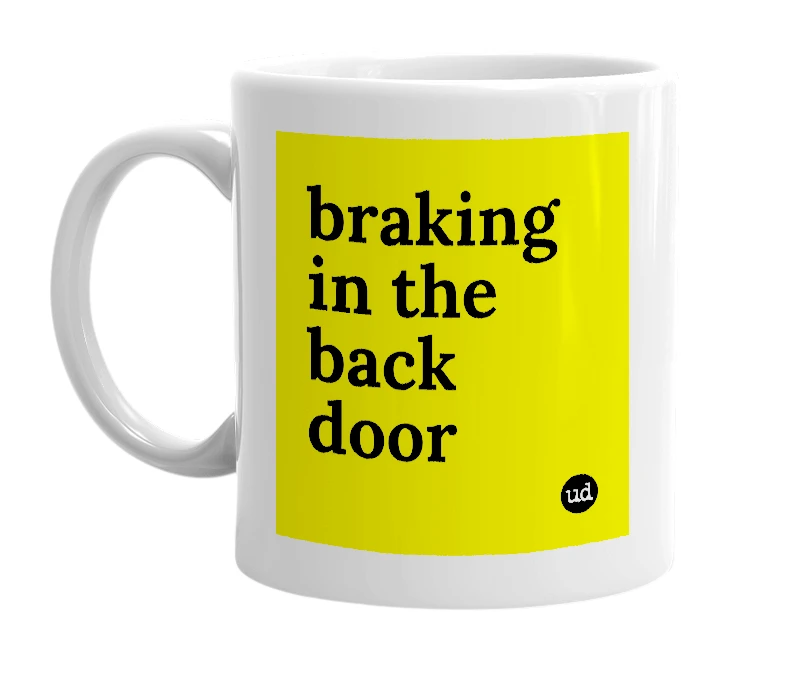 White mug with 'braking in the back door' in bold black letters