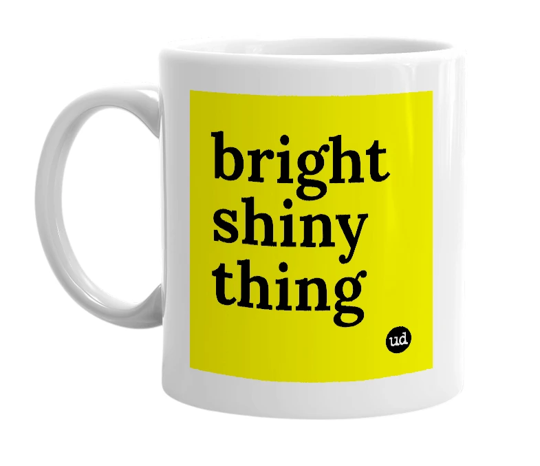 White mug with 'bright shiny thing' in bold black letters