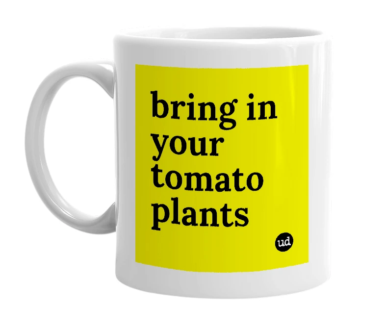 White mug with 'bring in your tomato plants' in bold black letters