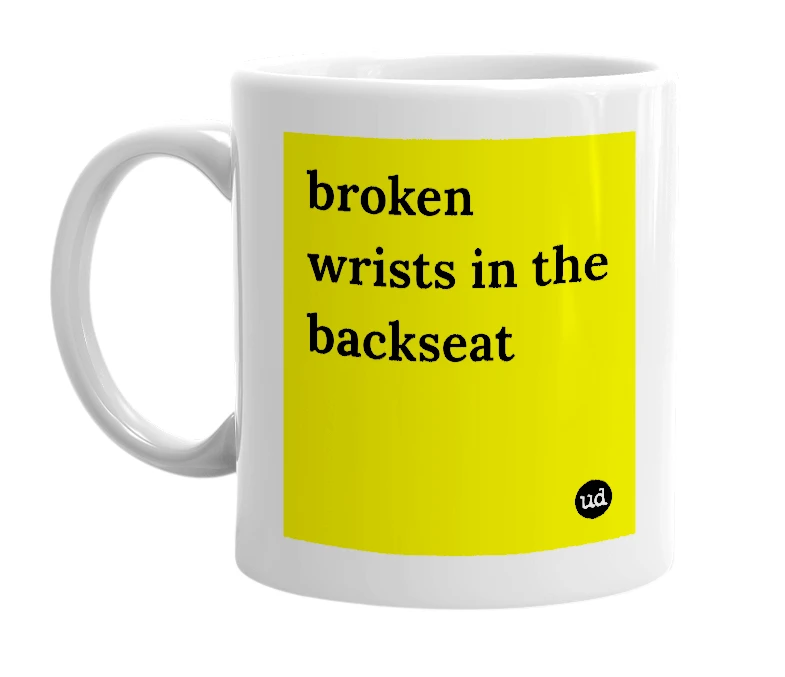 White mug with 'broken wrists in the backseat' in bold black letters